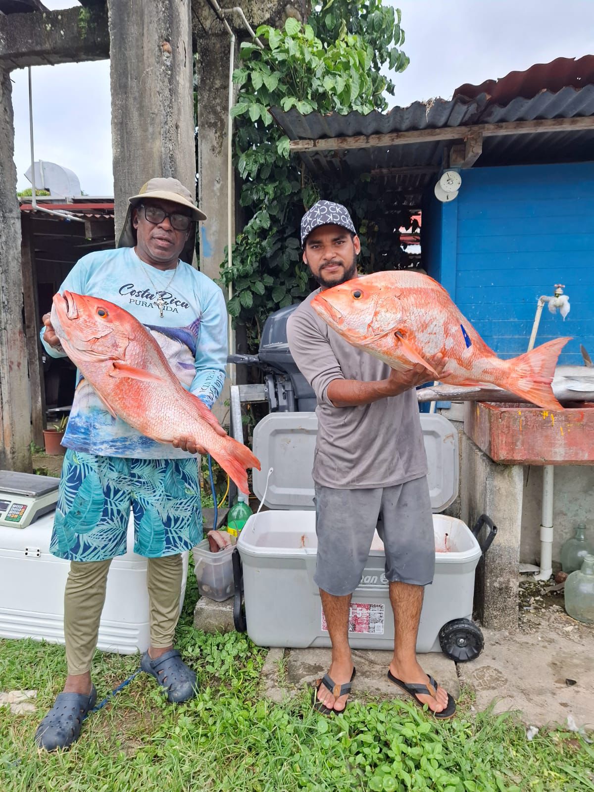 Fishermen from La Casa de la Langosta holding fresh catch