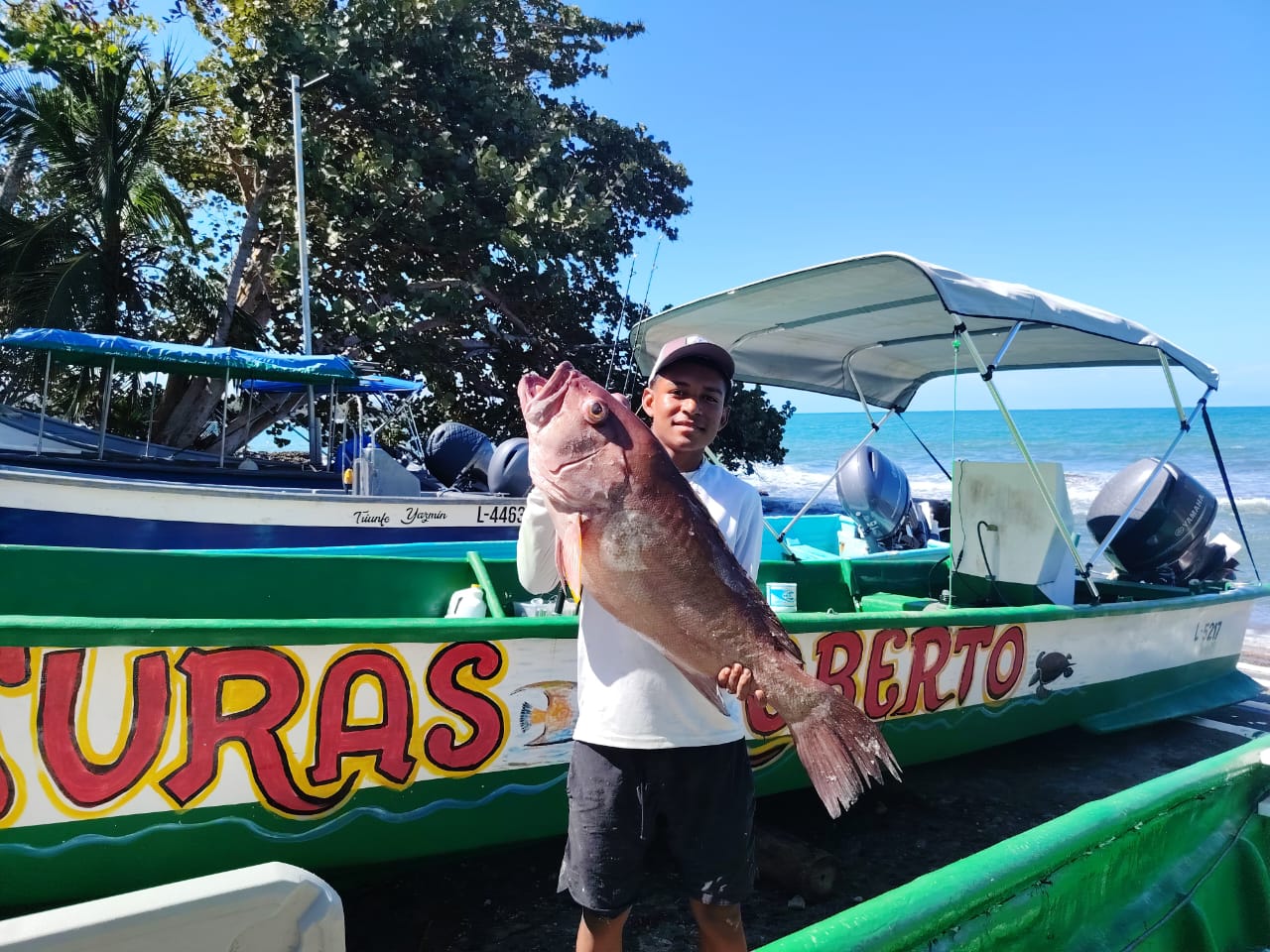 Fresh catch beside a Roberto Tours fishing boat in Cahuita