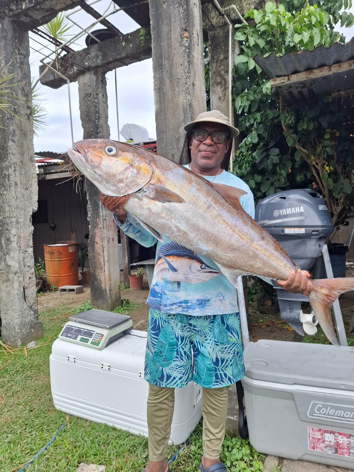 Chef Roberto holding a large fresh fish after a fishing trip